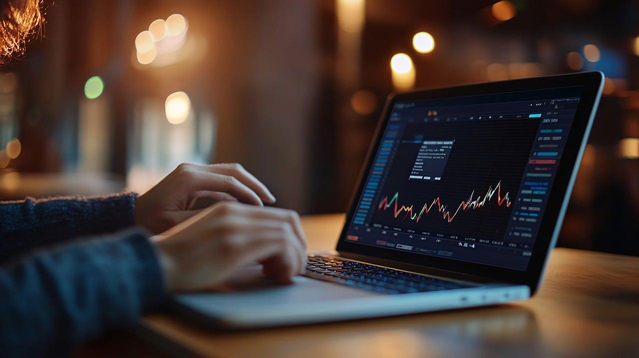 Trader analyzing crypto market data on a laptop