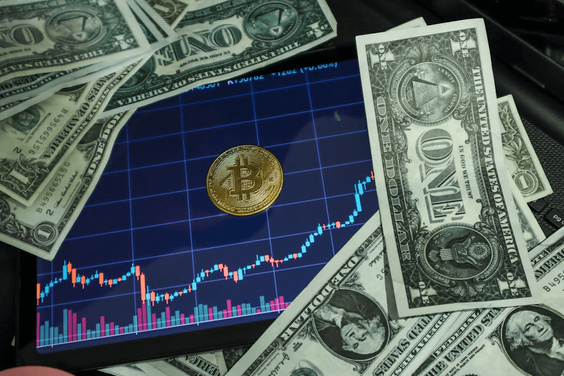 A pile of cash with a Bitcoin