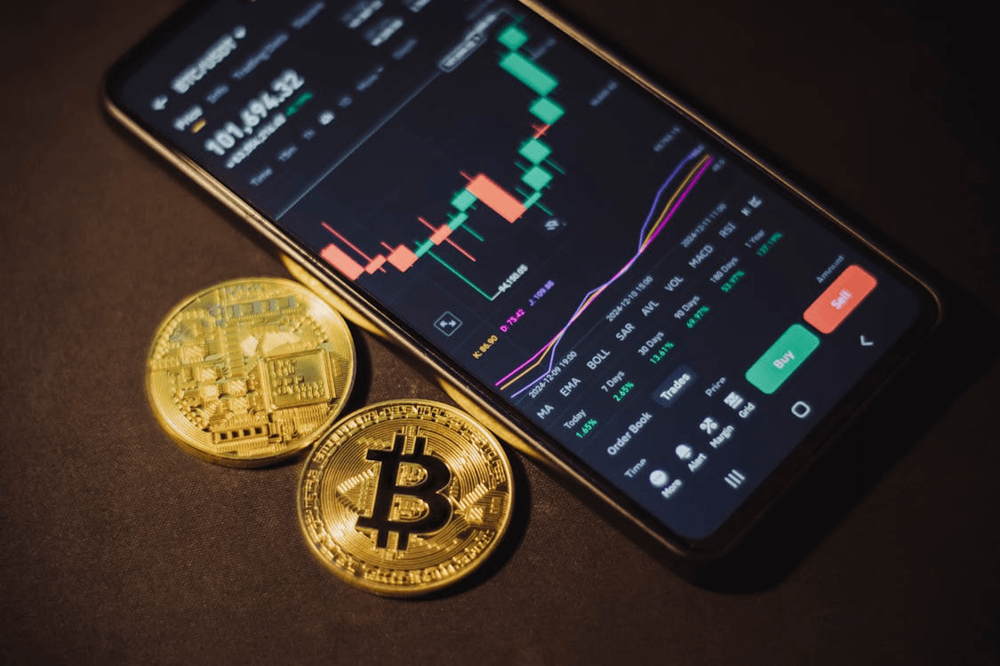 Cell phone displaying a bitcoin next to a