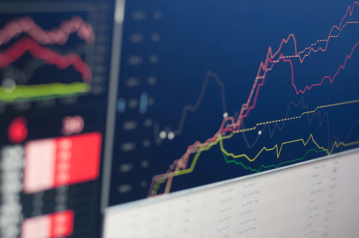 computer screen displaying crypto market graphs