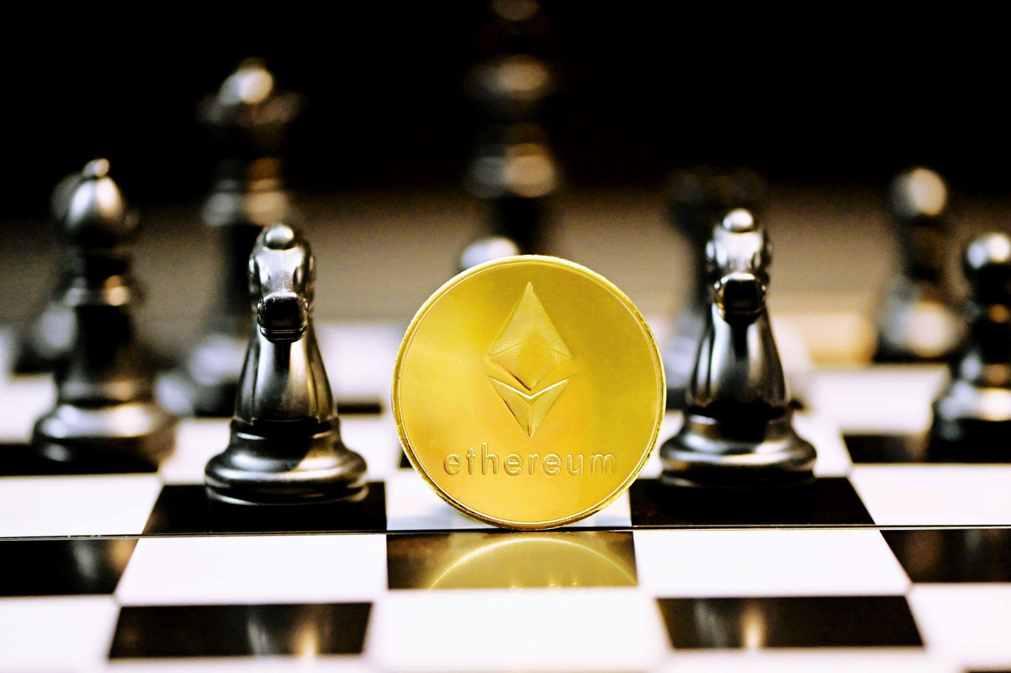 Gold Ether coin on a chessboard