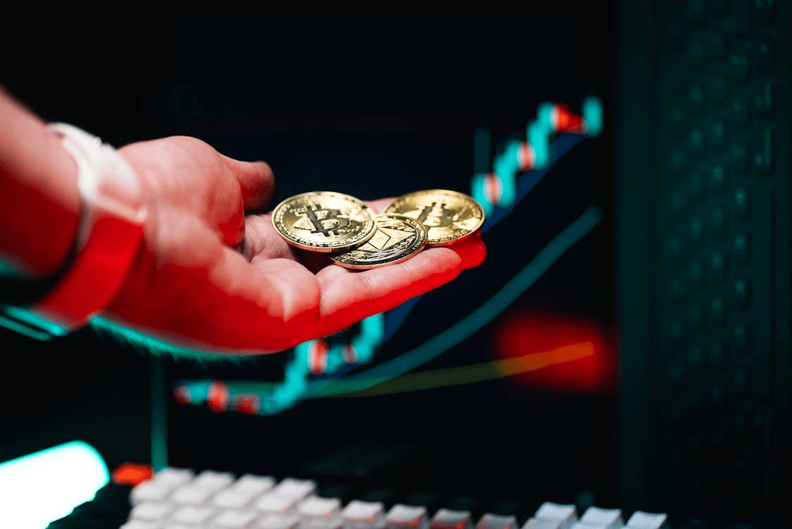 Person holding two gold coins, symbolizing cryptocurrency investment