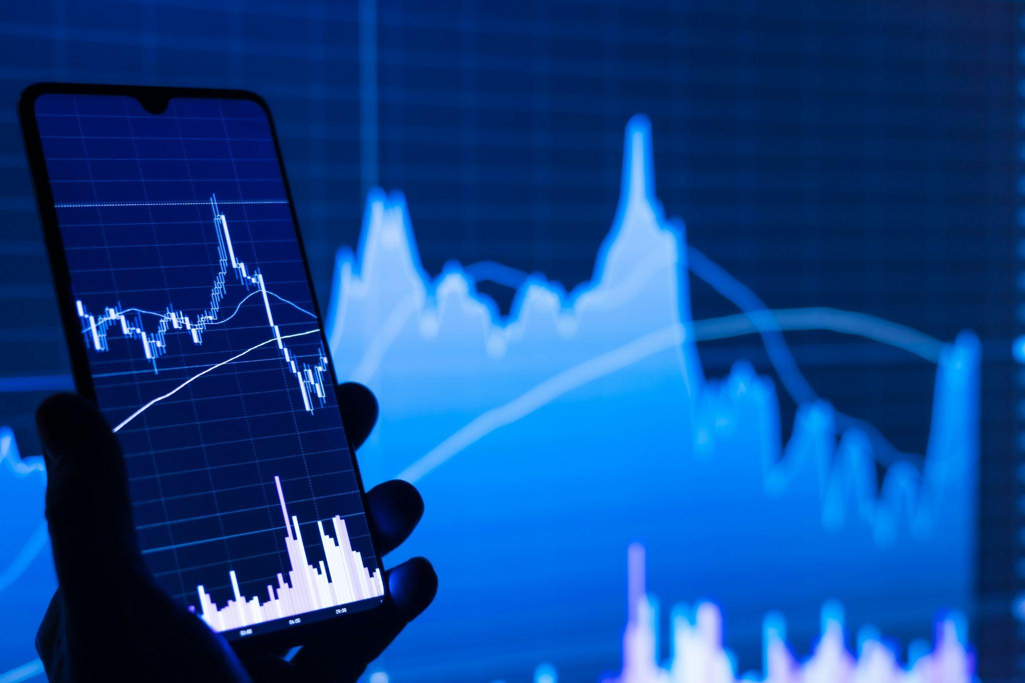 Person views a crypto stock chart on a phone