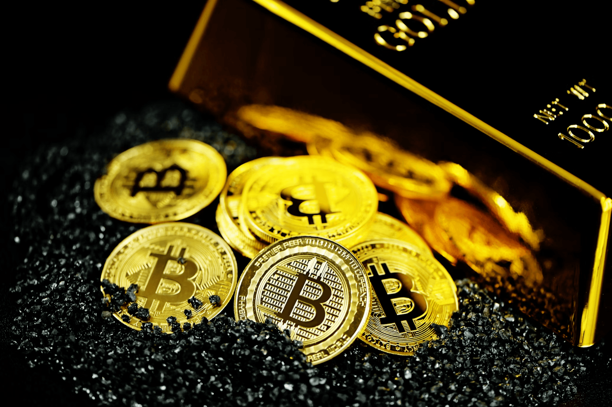 Pile of gold bitcoins next to a gold wallet