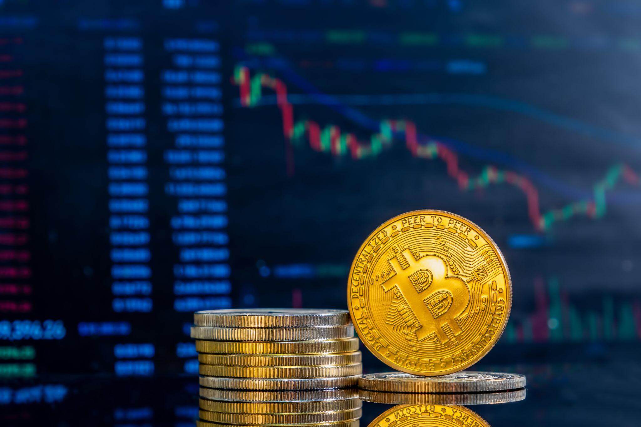 Bitcoin coin on a stack of cryptocurrency